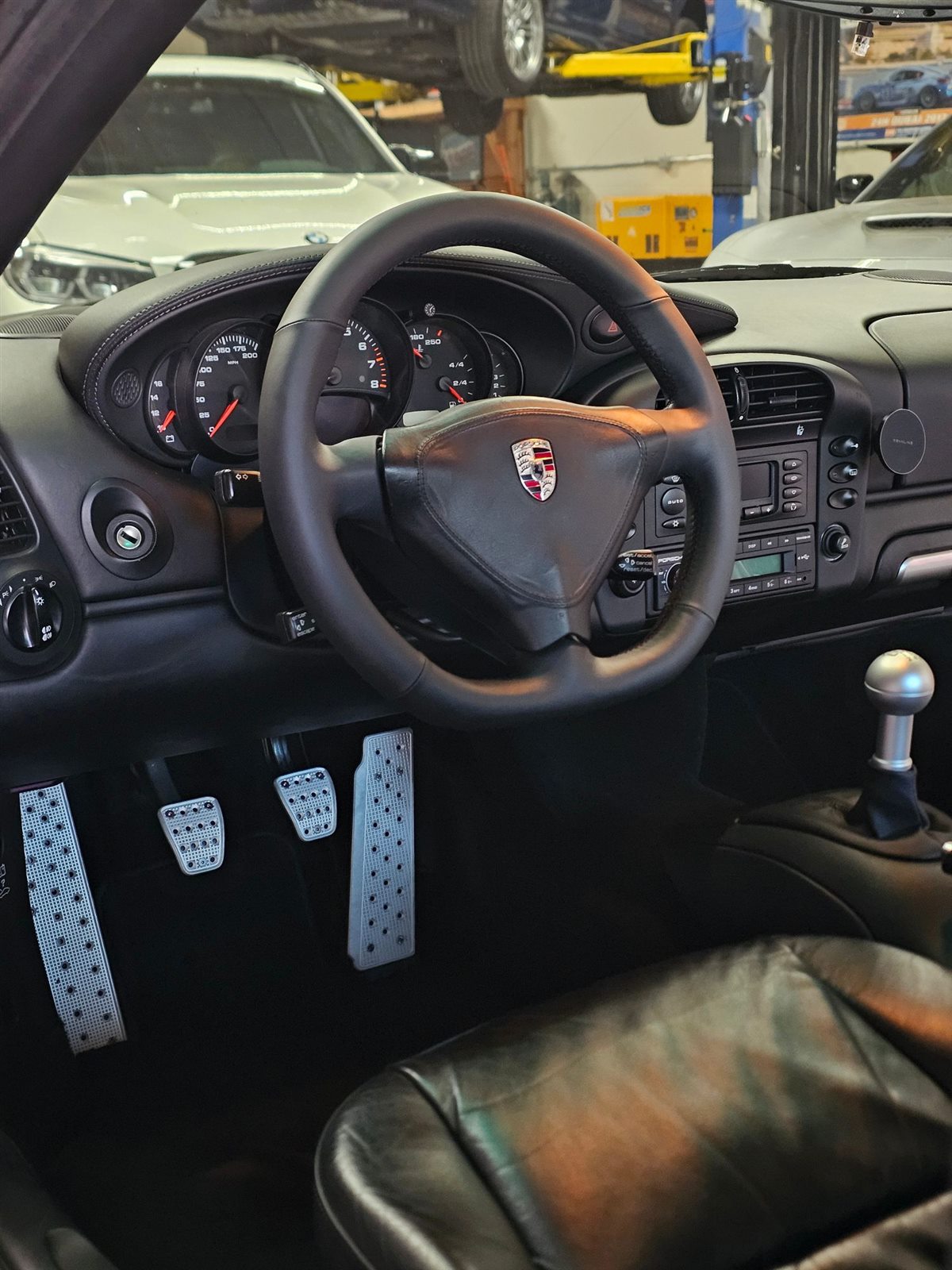 Manual Porsche 996 Turbo interior showing the clutch, brake and gas pedals and the shifter