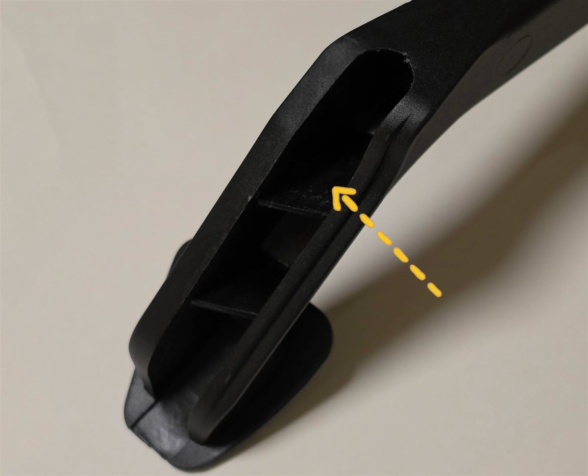 Back of the clutch pedal with an arrow pointing into the cavity to clean