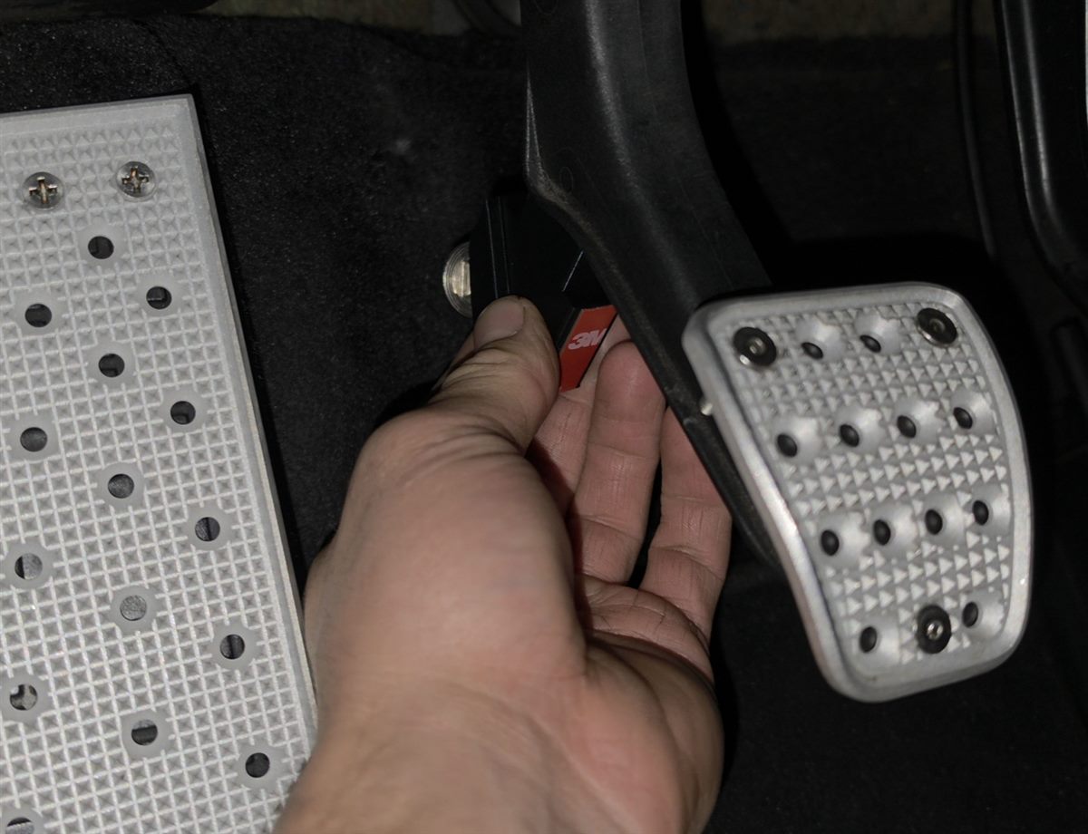 Holding the clutch stop, red 3M backing still on, in position behind the clutch pedal